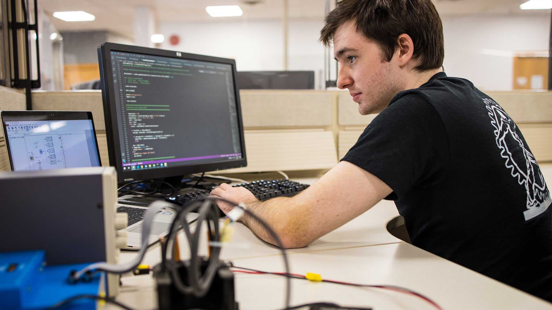 Multimatic Electronic Systems - Man working on computer software