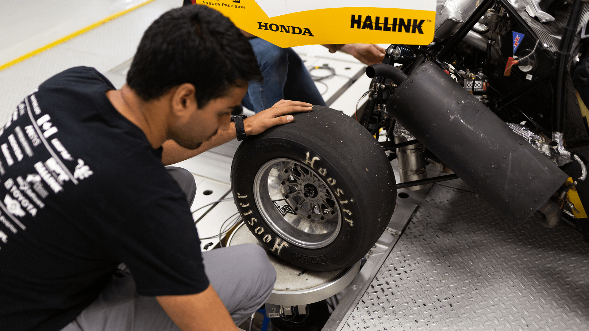 FSAE students working on 4 post rig.